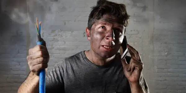 A man with brown eyes talking on his cell phone.