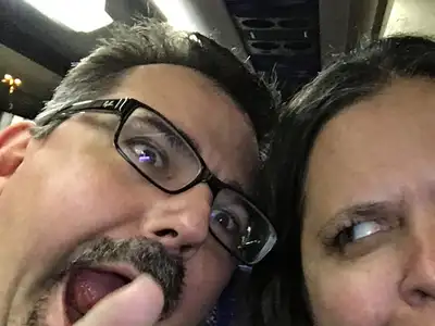 A man and woman are posing for the camera.