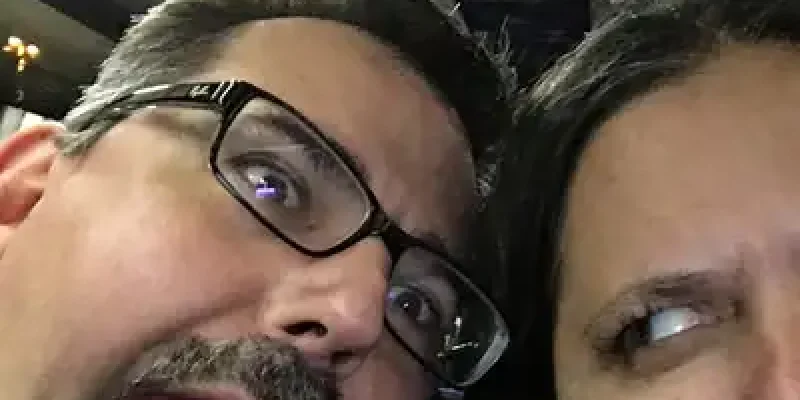 A man and woman are posing for the camera.