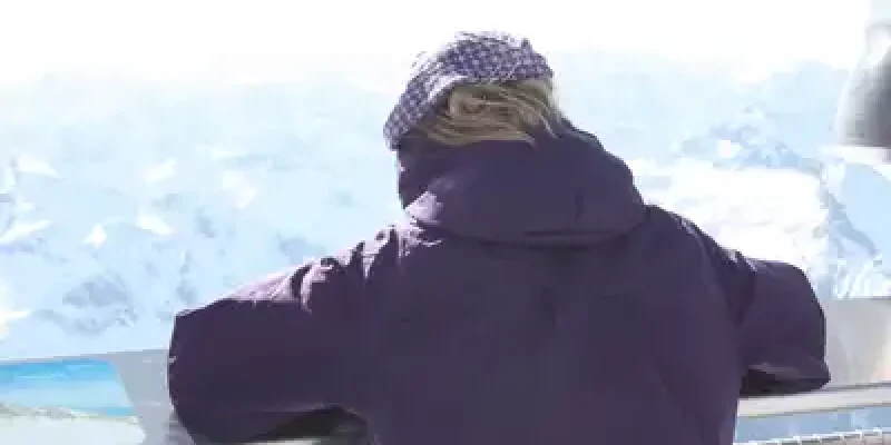 A person standing on top of a building looking at the sky.
